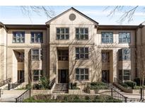 Tan three-story townhome with multiple windows and a center entrance at 3475 Oak Valley Rd # 130, Atlanta, GA 30326