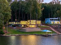 Luxury lakefront home with modern design, expansive windows, and private dock at 2746 Emerald Dr, Jonesboro, GA 30236