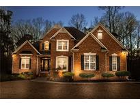 Brick home with landscaped yard and walkway at 340 Huiet Dr, Mcdonough, GA 30252