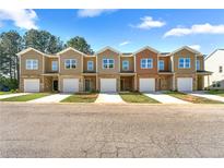 New townhomes feature brick and neutral siding, garages, and well-maintained lawns at 3607 Brycewood Dr, Decatur, GA 30034