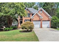 Brick two-story house with a two-car garage and landscaped lawn at 1166 Fords Lake Nw Pl, Acworth, GA 30101