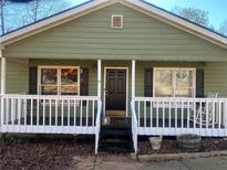 Ranch home with front porch and rocking chairs at 1638 River Trce, Auburn, GA 30011