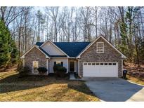 Brick and shingle ranch home with attached garage and wooded setting at 2183 Hampton Se Trl, Conyers, GA 30013