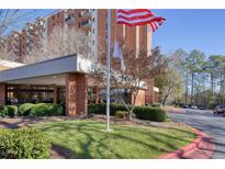 Brick building exterior with landscaping and flag at 300 Johnson Ferry Ne Rd # A706, Atlanta, GA 30328