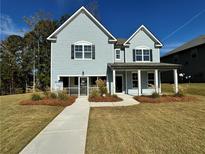 Two-story house with light blue siding, a front porch, and landscaping at 4005 Riverchess Lot 127 Sw Dr, Atlanta, GA 30331