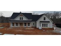 Two-story farmhouse with gray siding, black roof, and a front porch at 1330 Temple Draketown Rd, Temple, GA 30179