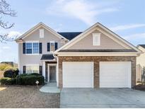 Two-story house with a two-car garage and neutral siding at 11602 Kades Trl, Hampton, GA 30228