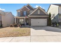 Brick two-story house with a large driveway and landscaped yard at 686 Westmoreland Ln, Lawrenceville, GA 30043