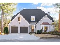 Two-story house with gray siding, two-car garage, and landscaping at 405 Ashdowne Way, Atlanta, GA 30350
