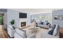 Spacious living room with hardwood floors and fireplace at 24214 Plantation Ne Dr, Atlanta, GA 30324