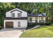 Two-story house with white siding, dark trim, and a two-car garage at 124 Cagle Way, Hiram, GA 30141