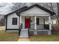 Charming renovated home featuring a bright red front door, covered porch, and fresh, modern paint at 967 Metropolitan Sw Pkwy, Atlanta, GA 30310