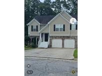 Two-story house with stone and siding, a two-car garage, and a landscaped yard at 4115 Brightmore Dr, Austell, GA 30106