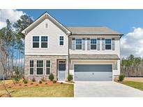 Charming two-story home with stone accents, manicured lawn, and a spacious two-car garage at 7293 Eton Ln, Locust Grove, GA 30248