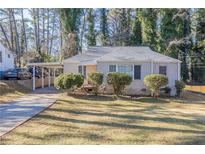 Ranch style home with carport, landscaping, and driveway at 1851 Ridgeland Dr, Decatur, GA 30032