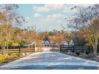 A long driveway leads to a charming farmhouse with a detached barn at 201 Edwards Brook Ct, Canton, GA 30115