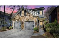 Stunning stone front exterior boasts a two-car garage and manicured landscaping at 1048 Standard Ne Dr, Atlanta, GA 30319