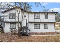 Two-story house with white siding, gray accents, and a wooden staircase at 2649 Porter Dr, Lawrenceville, GA 30044