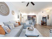 Bright living room with comfy couch and large windows at 955 Juniper St Ne # 4022, Atlanta, GA 30309