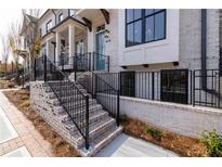 Front exterior of a charming townhome with brick facade and a teal door at 530 Fisher Dr # 45, Alpharetta, GA 30009