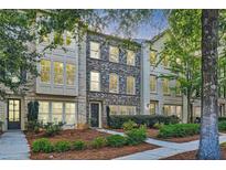 Three-story townhouses with brick exteriors and landscaped yards at 9972 Ashton Old Rd, Douglasville, GA 30135