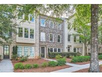 Three-story brick townhouses with lush landscaping at 9972 Ashton Old Rd, Douglasville, GA 30135