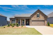 Inviting ranch home with stone accents and a landscaped lawn at 780 Codex Dr, Fairburn, GA 30213