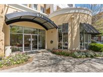 Modern building exterior with landscaped flowerbeds and a welcoming entrance at 870 Inman Village Pkwy # 203, Atlanta, GA 30307