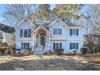 Two-story house with blue siding, stone accents, and a landscaped yard at 1123 Cool Springs Nw Dr, Kennesaw, GA 30144