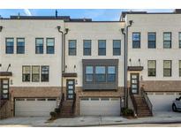 Townhome exterior with brick and white paint and attached garages at 4382 Benfield Se Way, Smyrna, GA 30080