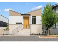 Modern two-toned home with a yellow door and landscaped yard at 145 Arcadia Ave, Fayetteville, GA 30214