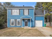 Charming two-story blue house with a gray door and attached garage at 3530 Kingsbrooke Ct, Decatur, GA 30034