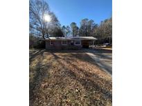 Brick ranch house with a large yard and driveway at 116 E Wade St, Oxford, GA 30054