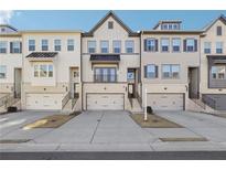 Three-story townhouses with attached garages and front stairs at 505 Stagecoach Bnd, Smyrna, GA 30080