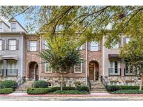 Brick townhouses with stone accents, steps, and landscaping at 2317 Saint Davids Nw Sq, Kennesaw, GA 30152