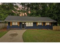 Newly renovated ranch home featuring a modern exterior, freshly painted in blue with orange accents at 2256 Barge Sw Rd, Atlanta, GA 30331