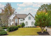 Two-story house with stone accents and landscaping at 3214 Burnette Ne Dr, Roswell, GA 30075