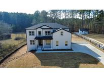 Two-story house with a large backyard and detached workshop at 2902 Centerville Rosebud Rd, Snellville, GA 30039