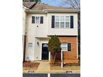Inviting two-story townhome with brick and siding exterior, featuring a charming front entrance at 4214 Quailbrook Ct, Tucker, GA 30084