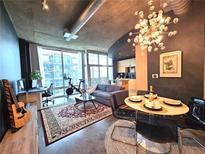 Open living space with dining area, city views, and Peloton at 923 Peachtree Ne St # 1825, Atlanta, GA 30309