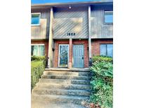 Inviting townhome entry with brick and gray siding at 1608 Briarcliff Ne Rd # 3, Atlanta, GA 30306