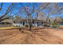Gray house with carport and fenced yard at 1395 W Austin Rd, Decatur, GA 30032