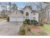 Two-story house with double garage and landscaped yard at 2691 Willow Green Dr, Duluth, GA 30096