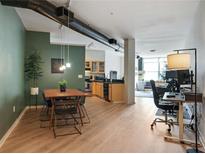 Open concept dining area with wood table and modern chairs at 800 Peachtree Ne St # 8529, Atlanta, GA 30308