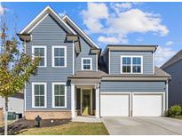 Two-story house with gray siding, white trim, and a two-car garage at 711 Bridgeview Dr, Holly Springs, GA 30115
