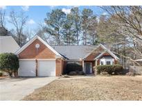 Brick house with two-car garage and landscaped yard at 447 Two Iron Nw Trl, Kennesaw, GA 30144