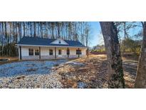 Newly constructed home with front porch and stone accents at 488 West Ave, Bowdon, GA 30108