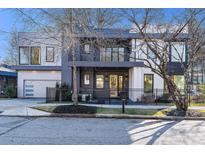 Modern two-story home with gray and white siding, a two-car garage, and a landscaped front yard at 1099 Hawthorne Ne St, Atlanta, GA 30307