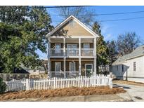 Two-story house with a front porch and white picket fence at 683 Terry Se St, Atlanta, GA 30315