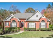 Brick house with gray roof, landscaping, and walkway at 6204 Woodlore Nw Dr, Acworth, GA 30101